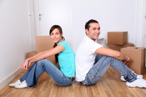 Movers carrying furniture through a narrow staircase in Southborough
